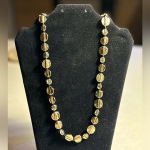 Hammered disk corded necklace in goldtone.